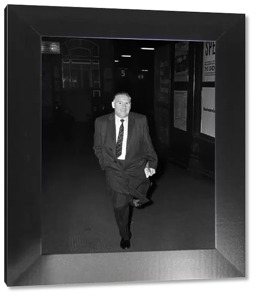 Tottenham Hotspur manager Bill Nicholson hurries out of Preston Station as he tries to