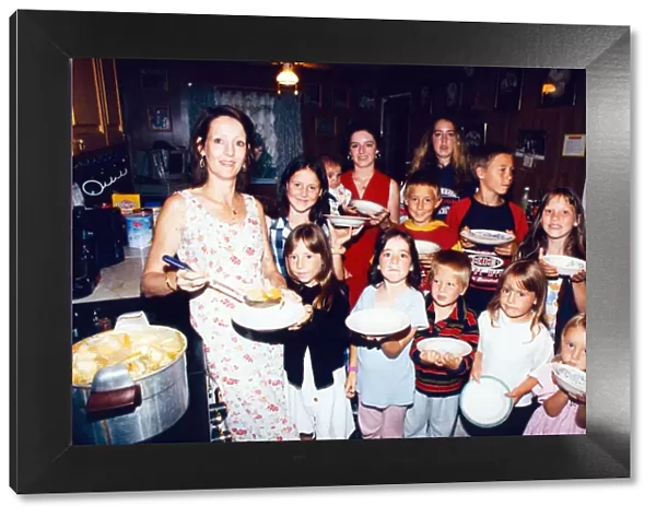 Feeding time in the Harvey household. Mother, Marie Harvey, pictured with her 13 children