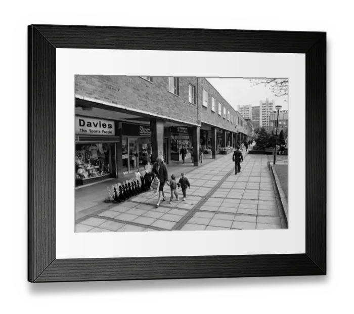 Framed Print : A mother and two young boys walk past the shops in Smithford Way, Coventry