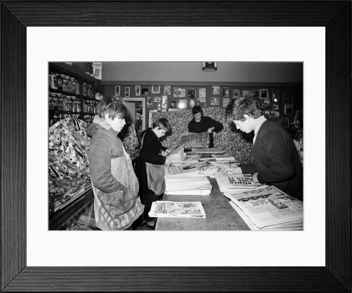 Framed Print : Newspaper round boys inside a newsagents, sorting the papers ready for delivery Framed Print : Newspaper round boys inside a newsagents, sorting the papers ready for delivery