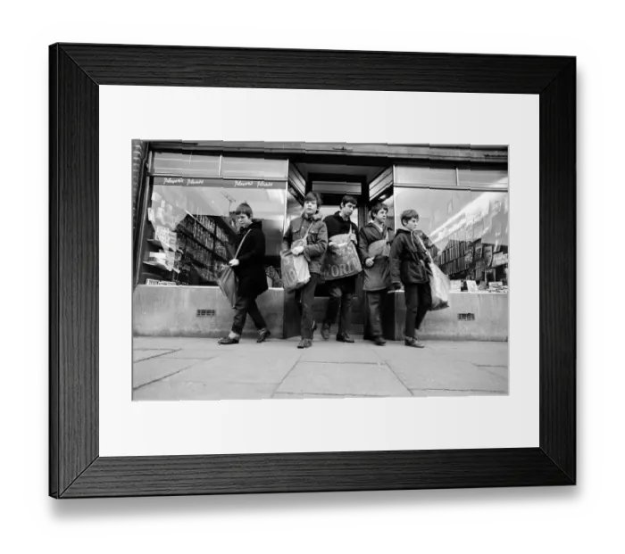 Framed Print : Newspaper round boys leaving the newsagents with their newspapers, ready for delivery Framed Print : Newspaper round boys leaving the newsagents with their newspapers, ready for delivery