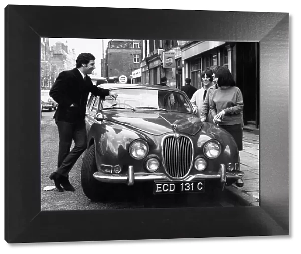 Welsh singing star Tom Jones shows off his new Jaguar car to three young fans in London