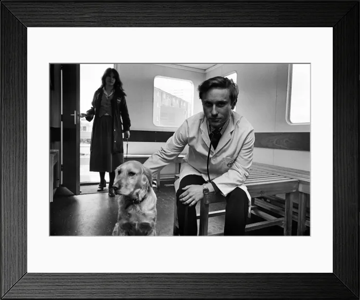 Framed Print : Its a dog life for this Birmingham vet. He is stationed in a mobile hut on land in Framed Print : Its a dog life for this Birmingham vet. He is stationed in a mobile hut on land in