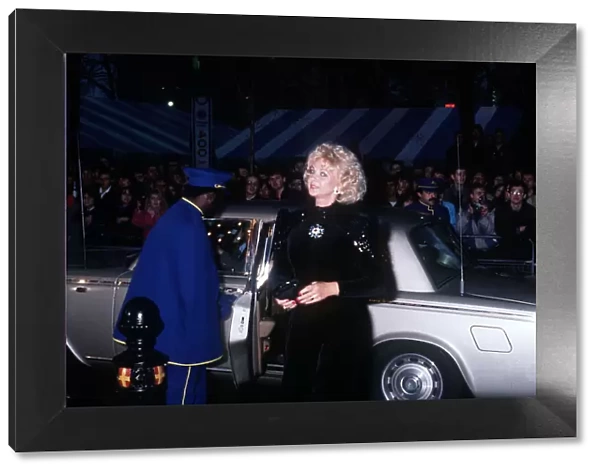 Mandy Rice Davies premiere film Absolute Beginners black dress car door opened by caped