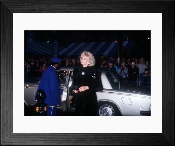 Framed Print : Mandy Rice Davies premiere film Absolute Beginners black dress car door opened by caped