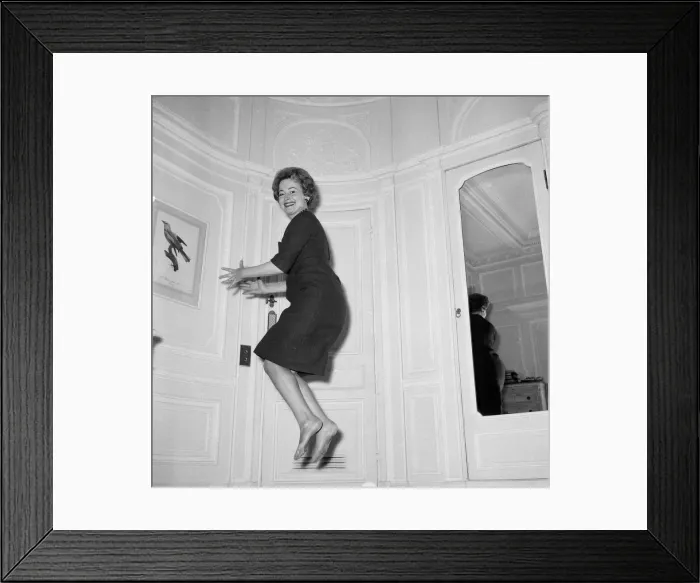 Framed Print : Olivia De Havilland playing a jumping game with her husband. 20th November 1959 Framed Print : Olivia De Havilland playing a jumping game with her husband. 20th November 1959