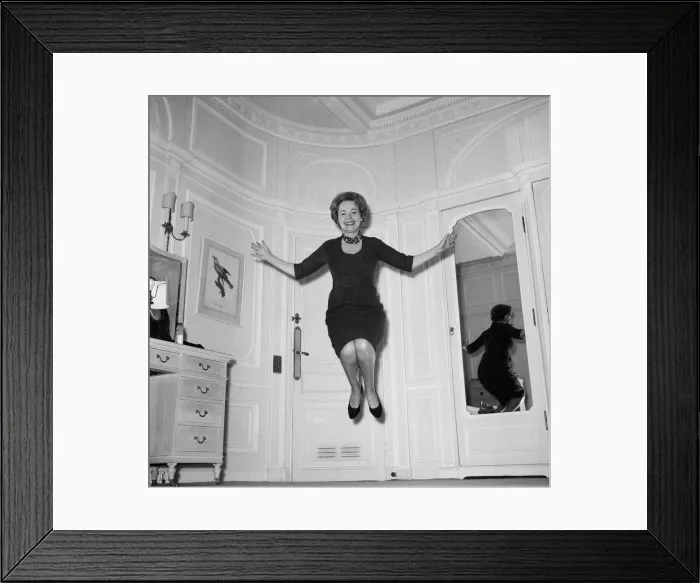 Framed Print : Olivia De Havilland playing a jumping game with her husband. 20th November 1959 Framed Print : Olivia De Havilland playing a jumping game with her husband. 20th November 1959