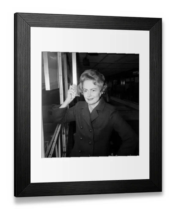 Framed Print : Olivia De Havilland listens to the budget at London Airport while waiting for a flight Framed Print : Olivia De Havilland listens to the budget at London Airport while waiting for a flight