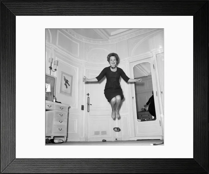Framed Print : Olivia De Havilland playing a jumping game with her husband. 20th November 1959 Framed Print : Olivia De Havilland playing a jumping game with her husband. 20th November 1959