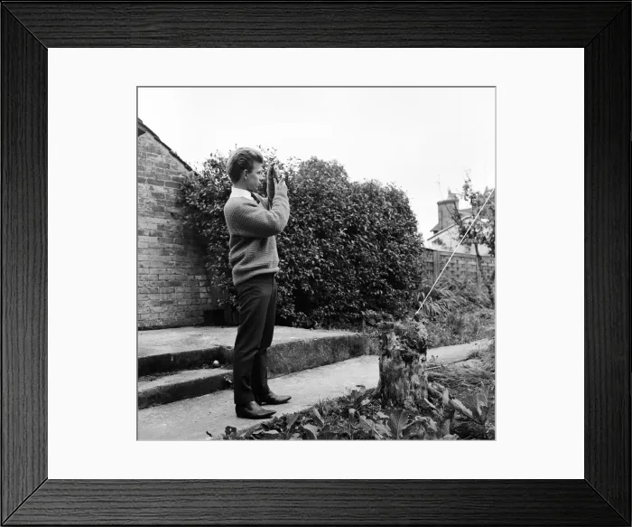 Framed Print : 23 year old Gordon Faulkner in his garden, holding the camera with which he photographed Framed Print : 23 year old Gordon Faulkner in his garden, holding the camera with which he photographed