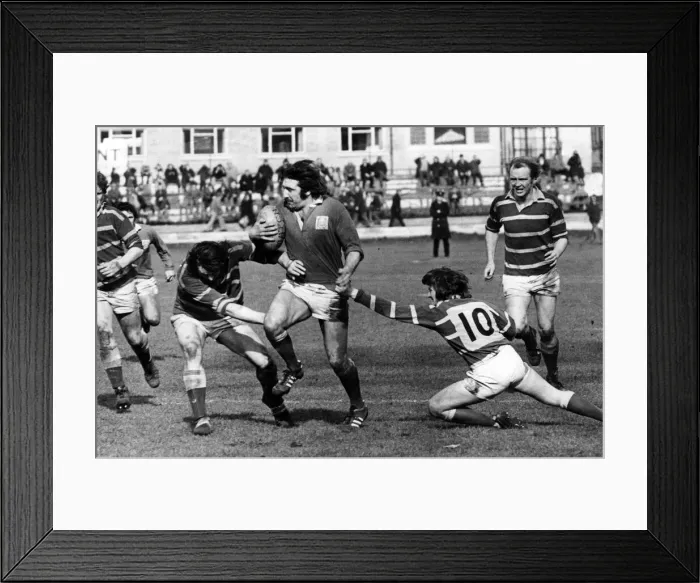 Framed Print : Llaneli forward Tommy David looks quite capable of taking on half the Bridgend team in Framed Print : Llaneli forward Tommy David looks quite capable of taking on half the Bridgend team in