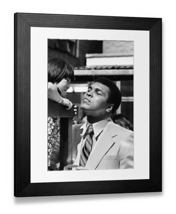 Framed Print : World Heavy-weight boxing champion Muhammad Ali with a little girl from Great Ormond