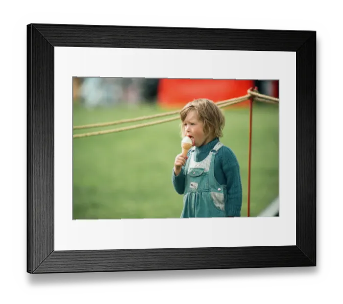 Framed Print : A little girl enjoys an ice-cream at Kirkleatham Country Fayre. 1st August 1993