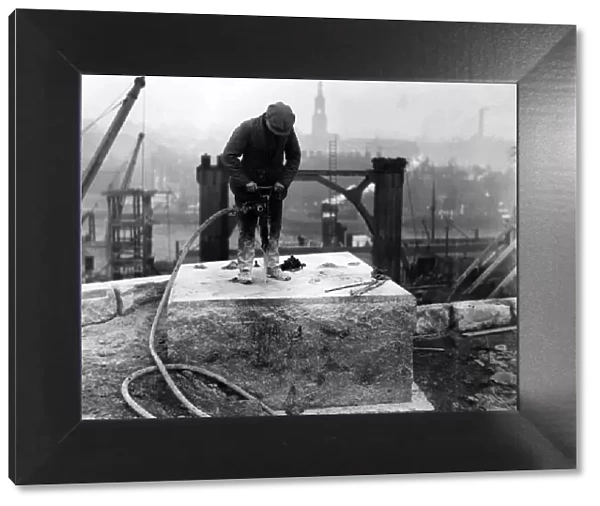 A workman drilling holes in one of the bedstones on the Gateshead abutment for