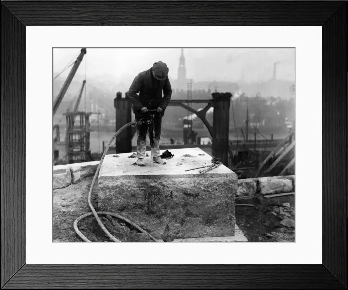 Framed Print : A workman drilling holes in one of the bedstones on the Gateshead abutment for