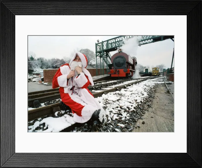 Framed Print : Santa stopped in his tracks. Father Christmas sitting on railway tracks Framed Print : Santa stopped in his tracks. Father Christmas sitting on railway tracks