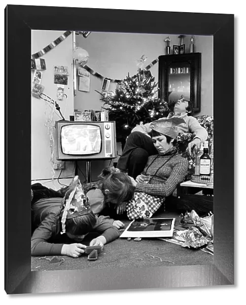 A typical family scene around the television on Christmas day
