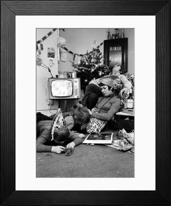 Framed Print : A typical family scene around the television on Christmas day Framed Print : A typical family scene around the television on Christmas day