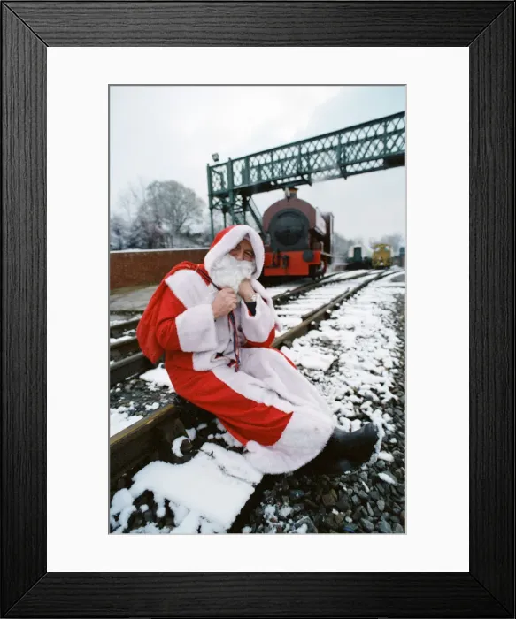 Framed Print : Santa stopped in his tracks. Father Christmas sitting on railway tracks Framed Print : Santa stopped in his tracks. Father Christmas sitting on railway tracks