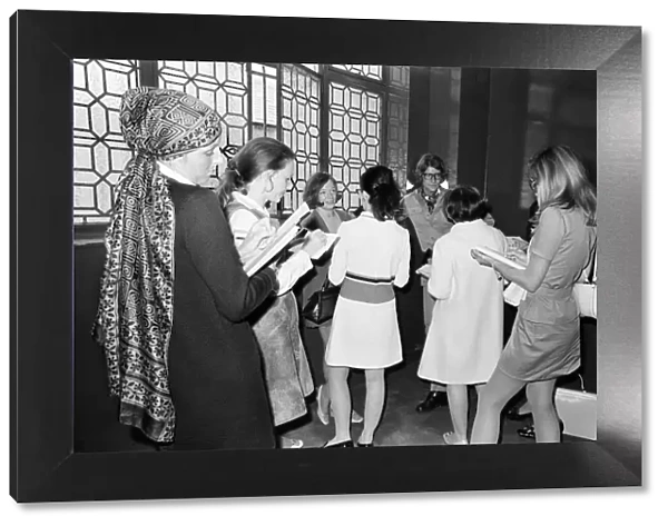 Yves Saint Laurent, designer, pictured speaking with journalists at the opening of his