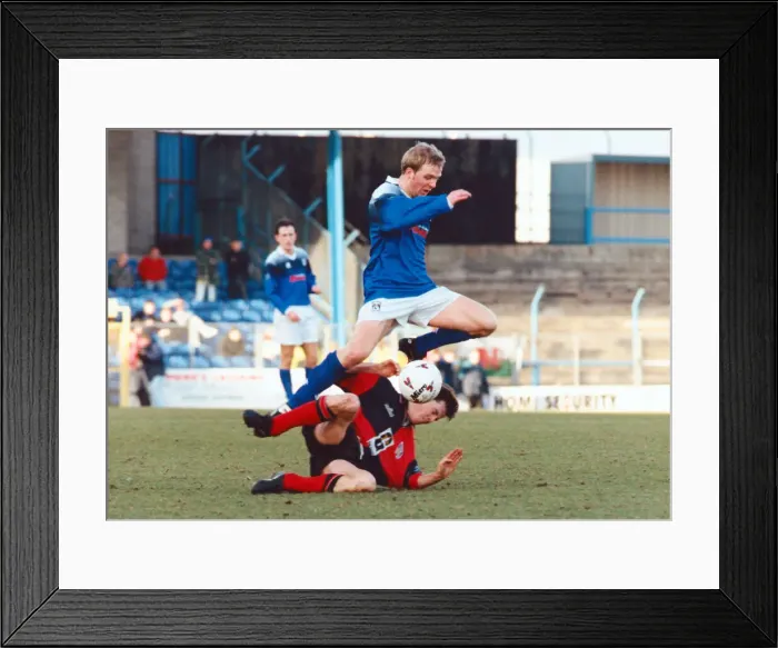 Framed Print : Cardiff City v Colchester United. Gareth Stoker of Cardiff jumps over a Colchester player Framed Print : Cardiff City v Colchester United. Gareth Stoker of Cardiff jumps over a Colchester player