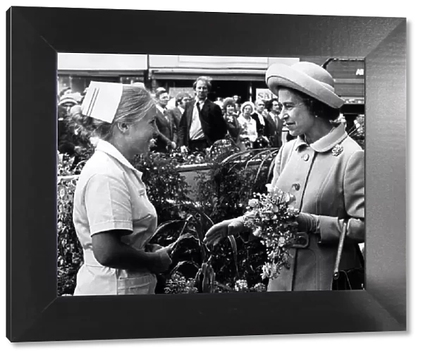 Nurse Susan Laskey presents a bouquet to Queen Elizabeth II as she arrives at Stockton