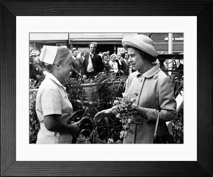 Framed Print : Nurse Susan Laskey presents a bouquet to Queen Elizabeth II as she arrives at Stockton