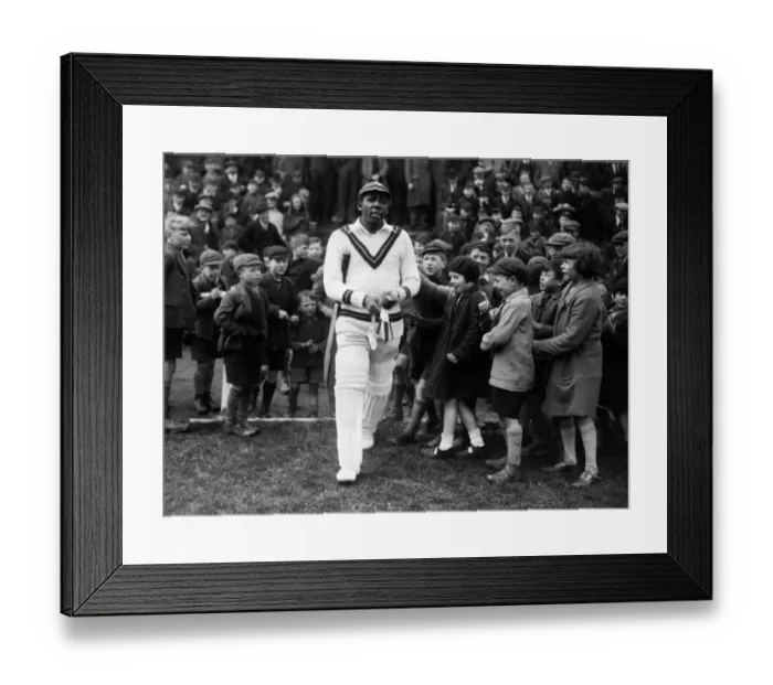 Framed Print : West Indies cricketer Learie Constantine walks out on to the field past excited children