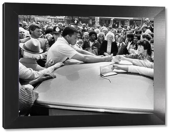 Fomer world boxing champion Muhammad Ali signs autographs for his Birmingham fans on his