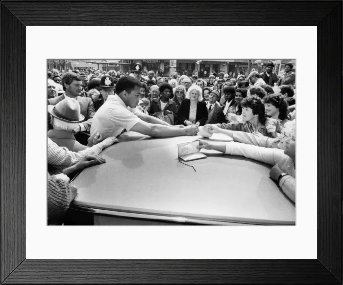 Framed Print : Fomer world boxing champion Muhammad Ali signs autographs for his Birmingham fans on his