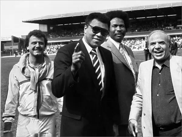 Muhammad Ali wave to the St Andrews crowd watched by councillor James Hunte