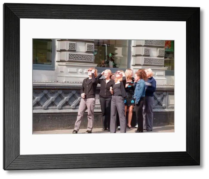 Framed Print : People watching a total solar eclipse, Queen Street, Cardiff. 11th August 1999 Framed Print : People watching a total solar eclipse, Queen Street, Cardiff. 11th August 1999