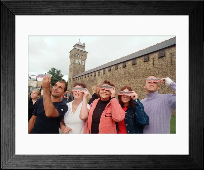 Framed Print : People watching a total solar eclipse, Queen Street, Cardiff. 11th August 1999 Framed Print : People watching a total solar eclipse, Queen Street, Cardiff. 11th August 1999