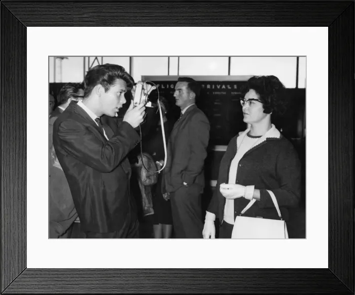 Framed Print : Cliff Richard taking a picture of his Mother at London Airport before leaving for New Framed Print : Cliff Richard taking a picture of his Mother at London Airport before leaving for New