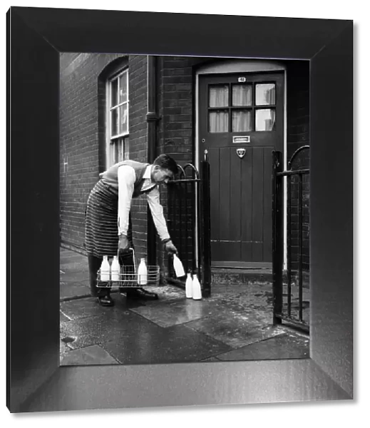 Milkman making doorstep delivery, January 1966