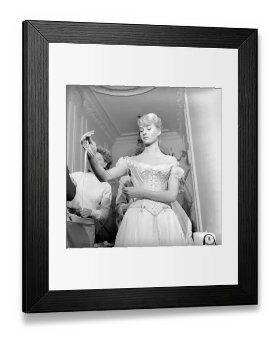 Framed Print : Members of the Wardrobe and make-up departments at Pinewood Studios help the actresses
