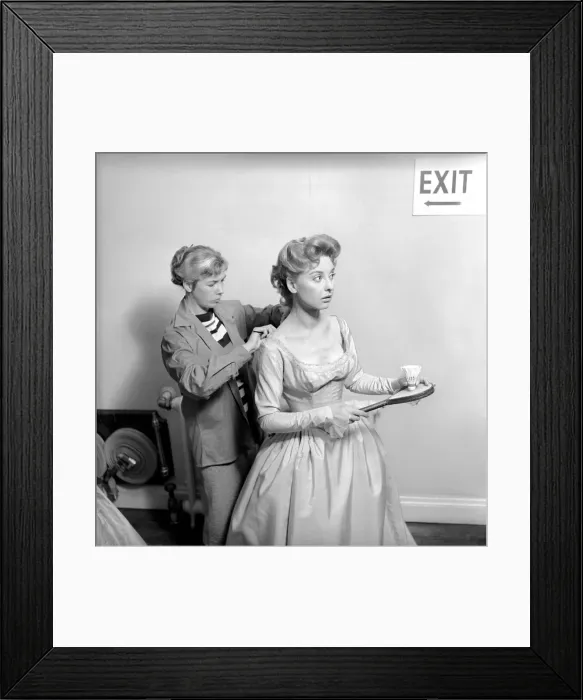 Framed Print : Members of the Wardrobe and make-up departments at Pinewood Studios help the actresses Framed Print : Members of the Wardrobe and make-up departments at Pinewood Studios help the actresses