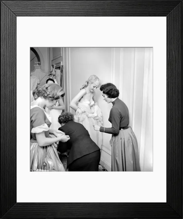 Framed Print : Members of the Wardrobe and make-up departments at Pinewood Studios help the actresses Framed Print : Members of the Wardrobe and make-up departments at Pinewood Studios help the actresses