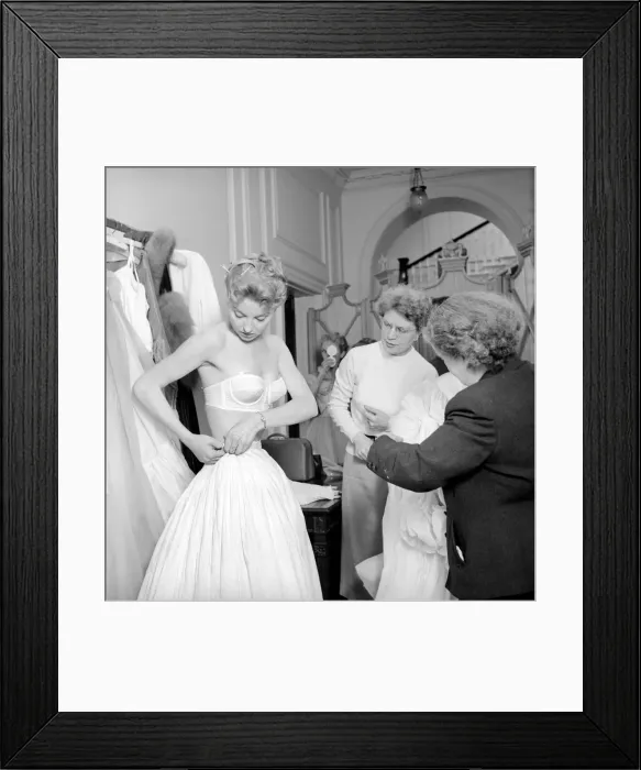 Framed Print : Members of the Wardrobe and make-up departments at Pinewood Studios help the actresses Framed Print : Members of the Wardrobe and make-up departments at Pinewood Studios help the actresses