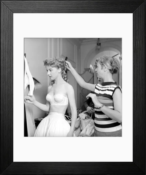 Framed Print : Members of the Wardrobe and make-up departments at Pinewood Studios help the actresses Framed Print : Members of the Wardrobe and make-up departments at Pinewood Studios help the actresses