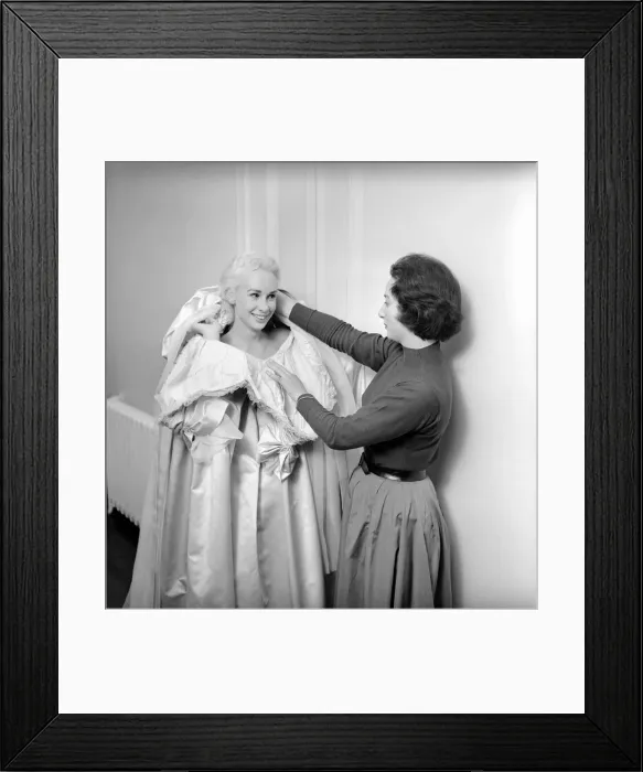 Framed Print : Members of the Wardrobe and make-up departments at Pinewood Studios help the actresses Framed Print : Members of the Wardrobe and make-up departments at Pinewood Studios help the actresses