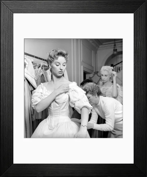 Framed Print : Members of the Wardrobe and make-up departments at Pinewood Studios help the actresses Framed Print : Members of the Wardrobe and make-up departments at Pinewood Studios help the actresses