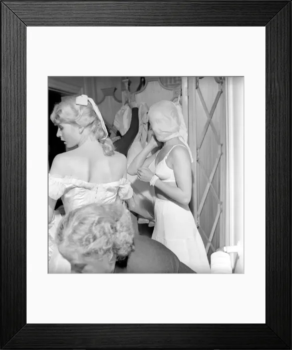 Framed Print : Members of the Wardrobe and make-up departments at Pinewood Studios help the actresses Framed Print : Members of the Wardrobe and make-up departments at Pinewood Studios help the actresses