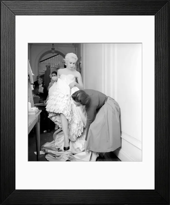 Framed Print : Members of the Wardrobe and make-up departments at Pinewood Studios help the actresses Framed Print : Members of the Wardrobe and make-up departments at Pinewood Studios help the actresses