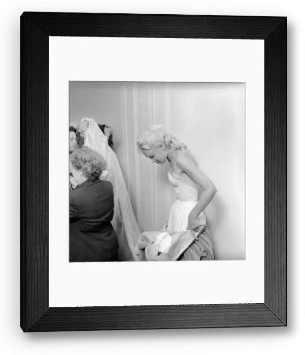 Framed Print : Members of the Wardrobe and make-up departments at Pinewood Studios help the actresses Framed Print : Members of the Wardrobe and make-up departments at Pinewood Studios help the actresses