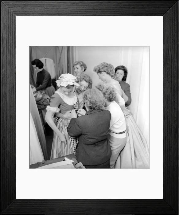 Framed Print : Members of the Wardrobe and make-up departments at Pinewood Studios help the actresses Framed Print : Members of the Wardrobe and make-up departments at Pinewood Studios help the actresses