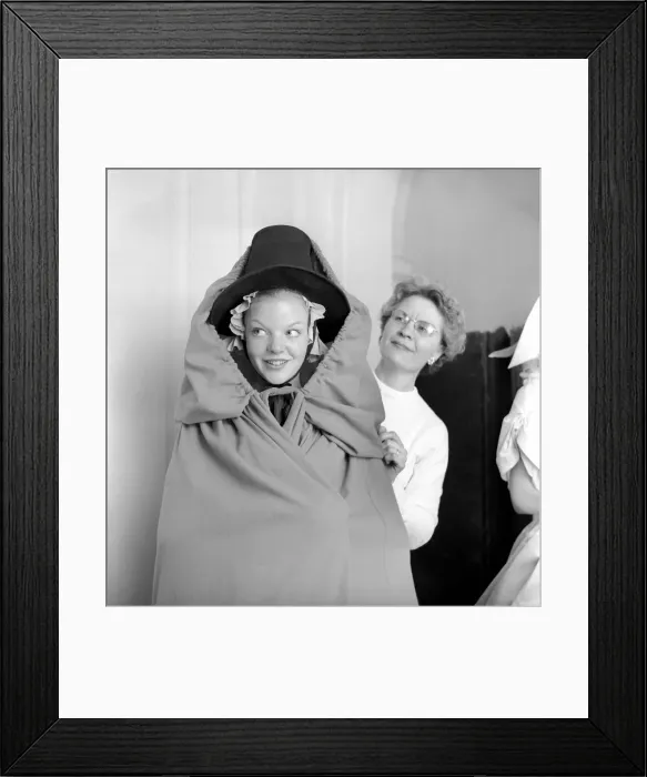 Framed Print : Members of the Wardrobe and make-up departments at Pinewood Studios help the actresses Framed Print : Members of the Wardrobe and make-up departments at Pinewood Studios help the actresses