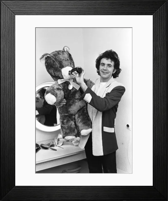 Framed Print : Singer and Actor David Essex poses with a teddy bear sent to him by a fan before going Framed Print : Singer and Actor David Essex poses with a teddy bear sent to him by a fan before going