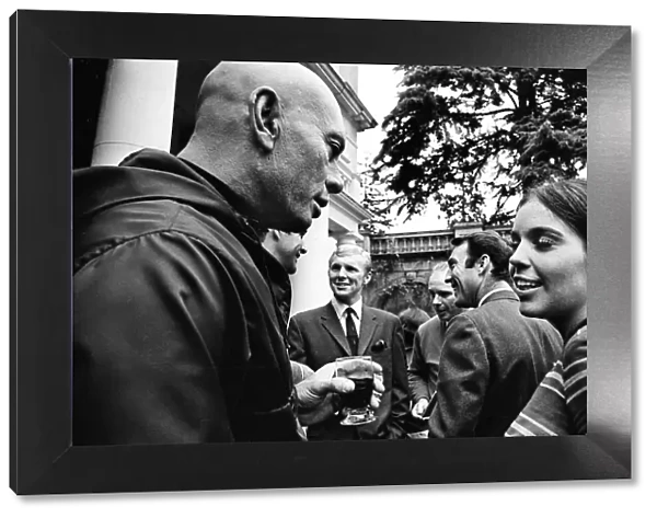 Actress Vivienne Ventura talks to Yul Brynner (left) with footballers Jimmy Greaves
