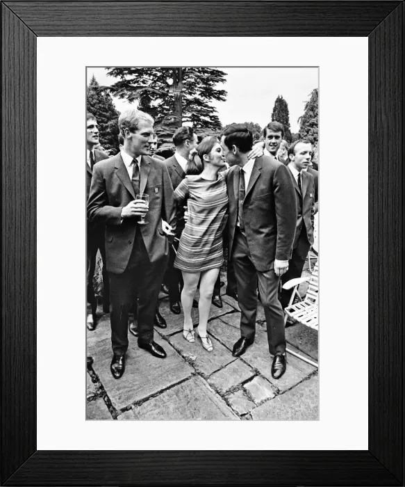 Framed Print : England footballer Gordon Banks gives a kiss to actress Vivienne Ventura watched by Ron